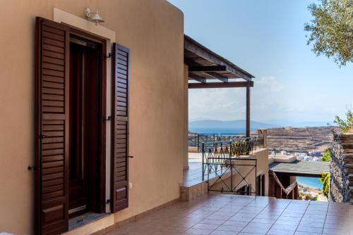 a door to the balcony of a house with a view at Villa Cavo d' Oro in Korissia