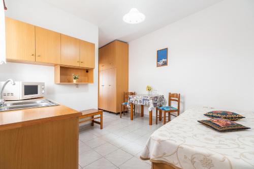 a kitchen with a sink and a table in a room at Acapulco 4 in Afantou