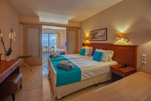 a hotel room with a bed and a balcony at Elounda Residence Resort & Waterpark in Elounda