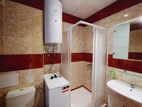 a bathroom with a shower and a toilet and a sink at Apartament Panorama - BastetBS in Sveti Vlas