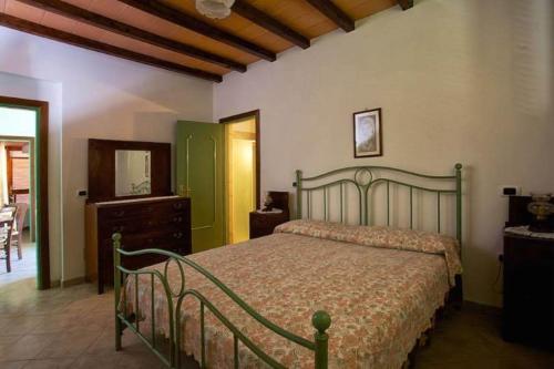 a bedroom with a bed and a dresser and a mirror at Agriturismo San Giuseppe in Gavorrano