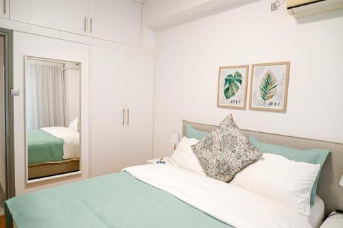 a bedroom with a bed and a mirror at Newly Renovated Apartment 7 min walk from Acropolis in Athens