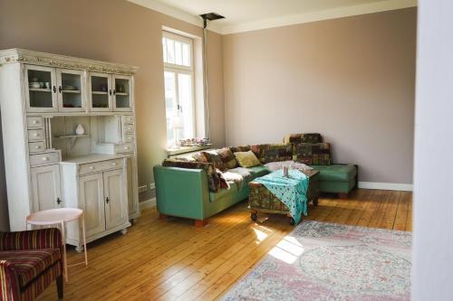 a living room with a couch and a table at Villa Rosa - Sky in Detmold