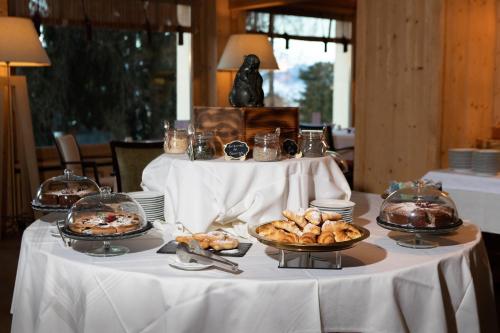 a table with plates of food on top of it at Hotel Royal in Crans-Montana