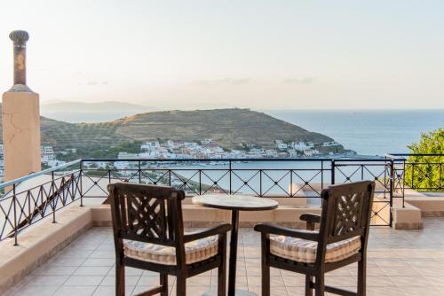 a table and chairs on a balcony with a view of the ocean at Villa Cavo d' Oro in Korissia