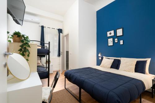 a bedroom with a bed with a blue wall at Affittacamere Z&I in Florence
