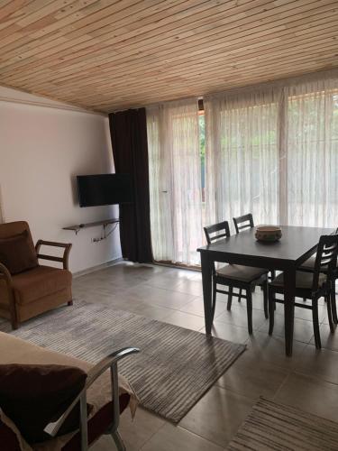 a living room with a dining room table and chairs at Adabella Pension in Cıralı