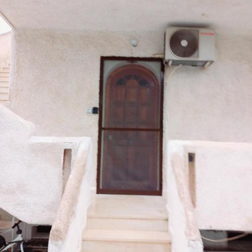 a door of a house with stairs and a speaker at Ξενώνας Vasiliki in Vathí