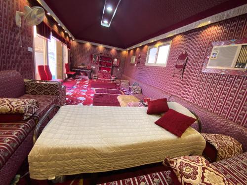a bedroom with two beds and a couch in a room at Modernistic Antique Stay in Jeddah