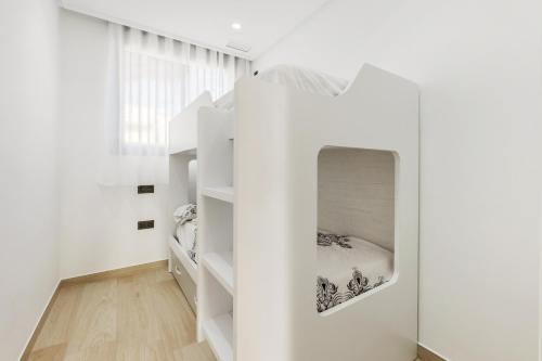 a room with white walls and white shelves at Portomarina VI in Pilar de la Horadada