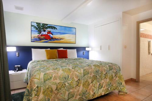 a bedroom with a bed and a painting on the wall at Royal Islander Club Resort La Terrasse in Lowlands