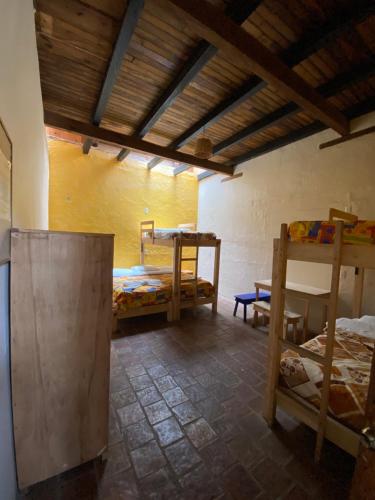 a room with two bunk beds and a table at Rossco Hostel & Hotel in San Cristóbal de Las Casas