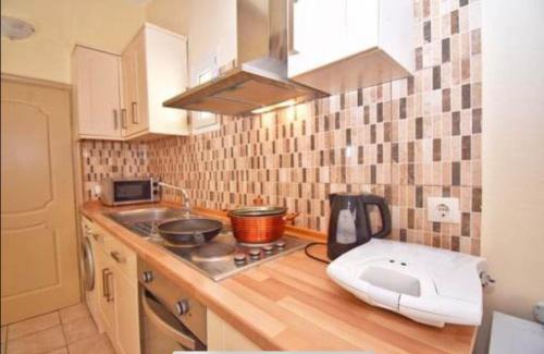 a small kitchen with a counter with a mixer in it at River Beach House in Mesongi
