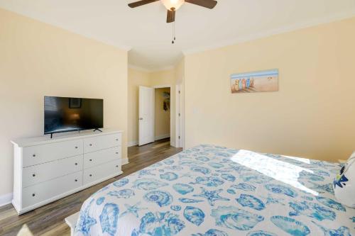 a bedroom with a bed and a flat screen tv at Emerald Isle Vacation Home Walk to Beach! in Emerald Isle
