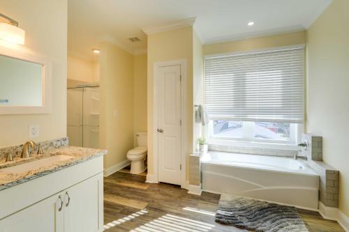 a bathroom with a large tub and a window at Emerald Isle Vacation Home Walk to Beach! in Emerald Isle