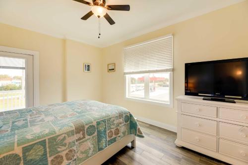 a bedroom with a bed and a flat screen tv at Emerald Isle Vacation Home Walk to Beach! in Emerald Isle