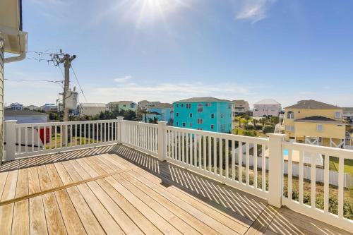 a balcony with a wooden deck with a view of buildings at Emerald Isle Vacation Home Walk to Beach! in Emerald Isle
