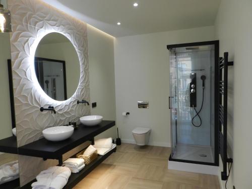 a bathroom with two sinks and a mirror at HOTEL MANEL in Martorell