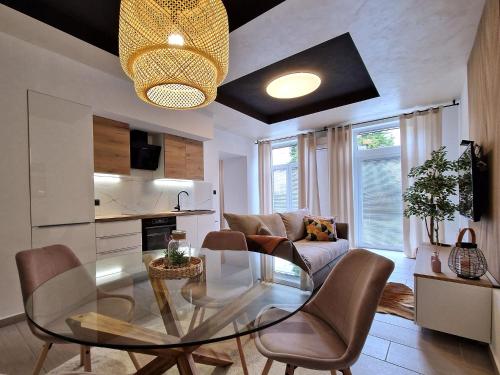 a living room with a glass table and chairs at Apartment Center Rogaška - Pubyland in Rogaška Slatina