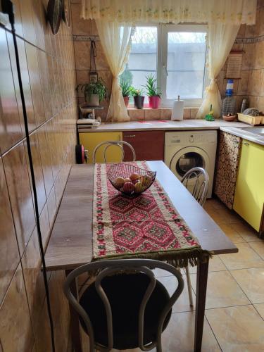 a kitchen with a table with a bowl on it at Casa/camere Maria in Corbu