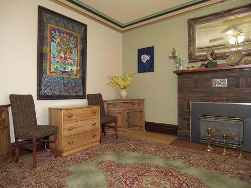 a living room with a fireplace and a mirror at Downtown Bed and Breakfast in Ottawa