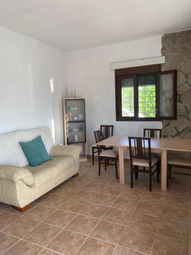 a living room with a couch and a table and chairs at Kalma experiencias turísticas in Cádiz