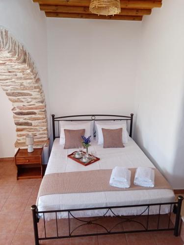 a bedroom with a large bed with two pillows at Monitsia Traditional House in Khalkíon