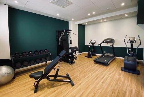 a gym with treadmills and exercise bikes in a room at Hotel Villa Letizia in Bardolino