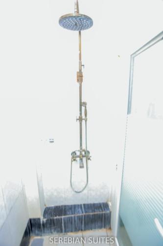 a shower in a bathroom with blue stairs at Serebian Suites in Mombasa