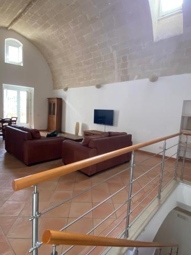 a living room with two couches and a tv at La Luna nei Sassi in Matera