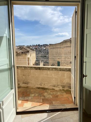 an open door to a balcony with a view at La Luna nei Sassi in Matera