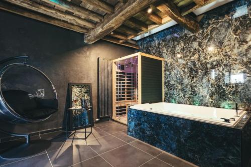 a large bathroom with a tub and a large window at Le Duplex de l'Etoile home cinéma jacuzzi et sauna privatif in Longmesnil