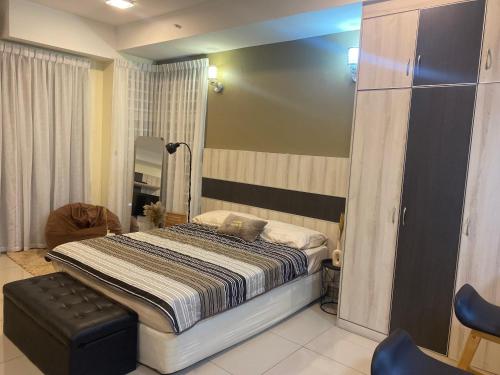 a bedroom with a bed and a chair in it at The Sugar'Barn Studio D Perdana kota bharu in Kota Bharu