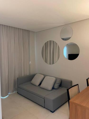 a living room with a couch and two mirrors at Salinas Exclusive Resort in Salinópolis
