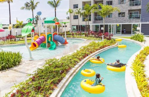 a pool at a resort with people riding in tubes at Salinas Exclusive Resort in Salinópolis