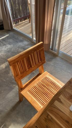 a wooden bench sitting on top of a porch at Bahía Santamaría in Moñitos