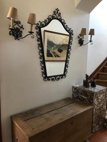 a mirror on a wall next to a wooden chest at Les colombages in Dinant