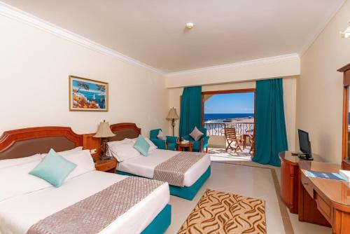 a hotel room with two beds and a balcony at Life Resorts Coral Hills Beach & SPA in Quseir
