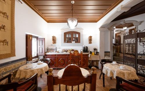a kitchen with two tables in a room at Casa de S. Thiago de Obidos in Óbidos
