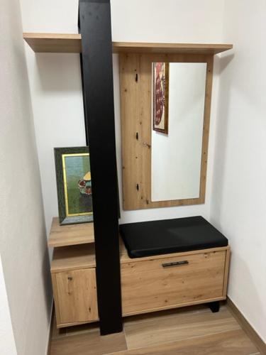 a wooden cabinet with a mirror on top of it at Villa Relax in Stresa