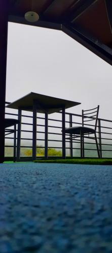 two benches sitting next to a fence at Foggy Mount View in Bandarawela