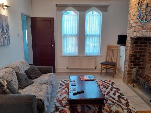 a living room with a couch and a coffee table at Victoria Villas in Sandycroft