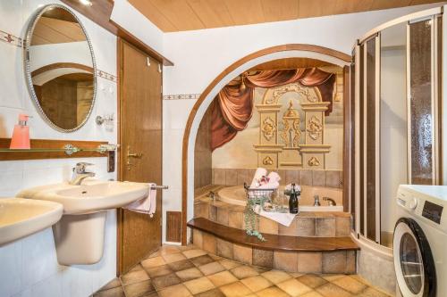 a bathroom with a sink and a washing machine at Haus Sonnenhang Wohnung 1 in Stiefenhofen