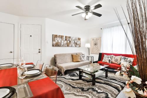a living room with a red couch and a ceiling fan at FREE PARKING in Beautiful Lachine in Montréal