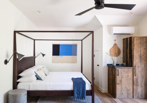 a bedroom with a bed with a ceiling fan at Contigo Ranch Fredericksburg in Fredericksburg