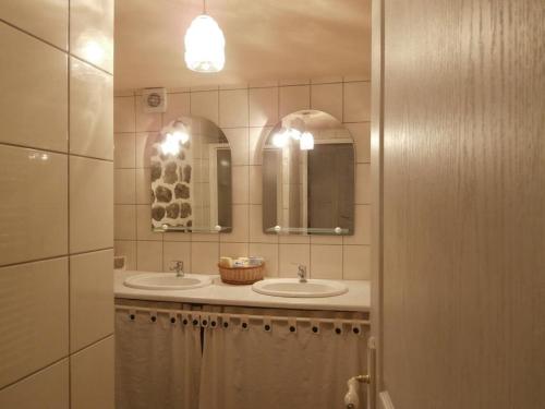 La salle de bains est pourvue de 2 lavabos et de 2 miroirs. dans l'établissement LE MYRO, à Péreyres