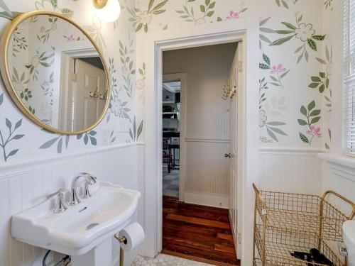 a bathroom with a sink and a mirror at Waldburg Cottage in Savannah