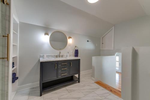 a bathroom with a sink and a mirror at Badin Lake Cabin with Dock and 2-Story Boat Slip! in New London