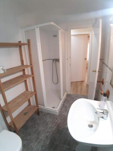 ムルシアにあるAPARTAMENTO TORRETAのシャワーと白い洗面台を備えたバスルーム