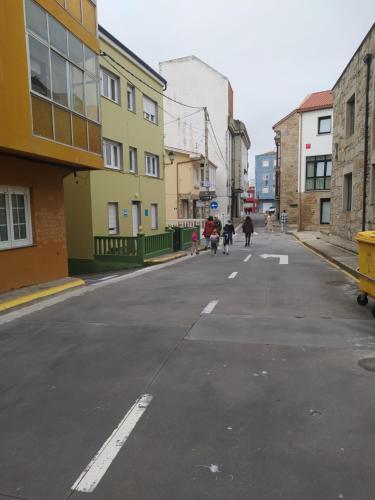 an empty street with people walking down the street at LIA in Muxia